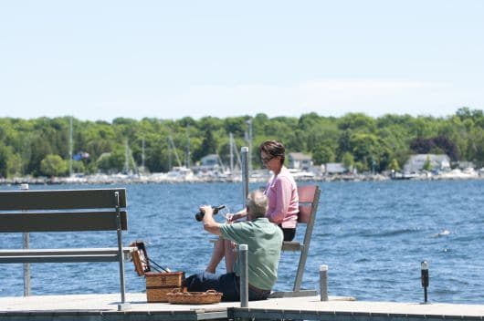 Couple on the shoreline dock at the Cuntry Huse esort in Wister bay, Door County WI