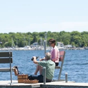 Couple on the shoreline dock at the Cuntry Huse esort in Wister bay, Door County WI